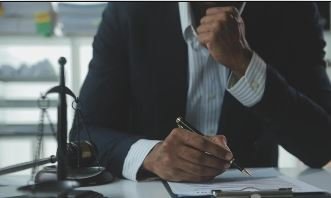 Business professional signing documents representing Regulatory & Compliance Advisory
